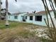 Light blue single story home with a yard at 205 163Rd Ave, Redington Beach, FL 33708