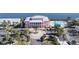 Pink building with waterfront access and palm trees at 239 Seahorse Se Dr # B, St Petersburg, FL 33705