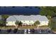 Aerial view of a yellow building with gray roof near a lake at 239 Seahorse Se Dr # B, St Petersburg, FL 33705