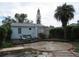 Charming home with a deck, lounge chairs, and a circular patio area at 3246 Prescott N St, St Petersburg, FL 33713