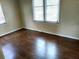 Bedroom with hardwood floors and two windows with blinds at 3246 Prescott N St, St Petersburg, FL 33713