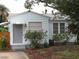 Charming light blue house with gray door, landscaping, and a walkway at 3246 Prescott N St, St Petersburg, FL 33713