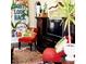 Living room showcasing a large TV, comfortable seating, and eclectic decor at 3246 Prescott N St, St Petersburg, FL 33713