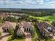 Aerial view of home and neighborhood, backing to golf course and mature trees at 4825 Benito Ct, Bradenton, FL 34211