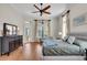 Spacious bedroom with hardwood floors, a ceiling fan, and views of the backyard at 4825 Benito Ct, Bradenton, FL 34211