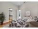 Comfortable bedroom with blue patterned bedspread, hardwood floors, and ensuite bathroom access for convenience at 4825 Benito Ct, Bradenton, FL 34211