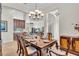Elegant dining room with a large wooden table, classic chairs, and open view to the living area at 4825 Benito Ct, Bradenton, FL 34211