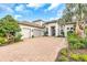 Beautiful single-Gathering home with a three car garage, a tile roof, and a brick driveway at 4825 Benito Ct, Bradenton, FL 34211