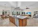 Spacious kitchen island with white marble countertop, stainless steel appliances, and open floor plan to living area at 4825 Benito Ct, Bradenton, FL 34211