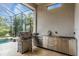 Outdoor kitchen area with stainless steel grill and ample counter space at 4825 Benito Ct, Bradenton, FL 34211