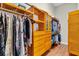 Spacious walk-in closet with custom wood shelving, drawers, and ample hanging space for organized storage at 4825 Benito Ct, Bradenton, FL 34211