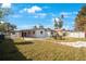 Backyard view showing house, patio, and grassy area at 6318 S Renellie Ct, Tampa, FL 33616