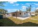 View of backyard with covered patio and grassy lawn at 6318 S Renellie Ct, Tampa, FL 33616