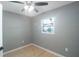 Bright bedroom with ceiling fan, light wood floors, and gray walls at 6318 S Renellie Ct, Tampa, FL 33616