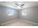 Well-lit bedroom with two windows, ceiling fan, and light floors at 6318 S Renellie Ct, Tampa, FL 33616