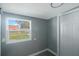 Bright bedroom with gray walls and a view of the backyard at 6318 S Renellie Ct, Tampa, FL 33616