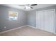 Bedroom with ceiling fan, double-door closet, and window at 6318 S Renellie Ct, Tampa, FL 33616