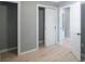 Bedroom with light gray walls, wood-look floors, and closets at 6318 S Renellie Ct, Tampa, FL 33616