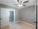 Bright bedroom with ceiling fan and access to another room at 6318 S Renellie Ct, Tampa, FL 33616