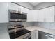 Modern kitchen with stainless steel appliances and white cabinets at 6318 S Renellie Ct, Tampa, FL 33616