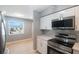 Bright kitchen featuring stainless steel appliances and white cabinets at 6318 S Renellie Ct, Tampa, FL 33616