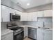 Modern kitchen with stainless steel appliances and white cabinets at 6318 S Renellie Ct, Tampa, FL 33616