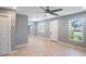 Light gray walls, hardwood floors, ceiling fan, and white door at 6318 S Renellie Ct, Tampa, FL 33616