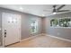 Light gray walls, hardwood floors, ceiling fan, and white door at 6318 S Renellie Ct, Tampa, FL 33616