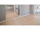Open living room and kitchen with light wood flooring at 6318 S Renellie Ct, Tampa, FL 33616