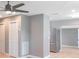 Light gray walls, hardwood floors, ceiling fan, and stainless steel refrigerator at 6318 S Renellie Ct, Tampa, FL 33616