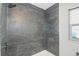 Modern shower with dark gray marble-look tile at 6318 S Renellie Ct, Tampa, FL 33616