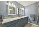 Double vanity bathroom with gray tile floors at 7183 Spinnaker Blvd, Englewood, FL 34224