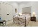 Cozy bedroom with an iron bed frame and soft color palette at 16920 Villalagos De Avila, Lutz, FL 33548