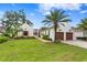 Mediterranean-style home with lush landscaping and two-car garage at 16920 Villalagos De Avila, Lutz, FL 33548