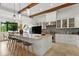 Modern kitchen with white cabinetry, a large island, and patterned backsplash at 16920 Villalagos De Avila, Lutz, FL 33548