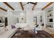 Spacious living area with exposed beams, comfortable seating, and a large chandelier at 16920 Villalagos De Avila, Lutz, FL 33548