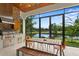 Outdoor kitchen with stainless steel appliances and a view of the golf course at 16920 Villalagos De Avila, Lutz, FL 33548