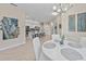 Round dining table, white chairs, and open view to the kitchen at 20644 Swallow Tail Ct, Venice, FL 34293