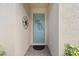 Light teal front door with decorative metalwork and brick flooring at 20644 Swallow Tail Ct, Venice, FL 34293