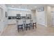 Modern kitchen with white cabinets, stainless steel appliances, and an island at 20644 Swallow Tail Ct, Venice, FL 34293