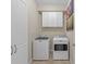 Functional laundry room with washer, dryer, and overhead cabinets at 20644 Swallow Tail Ct, Venice, FL 34293