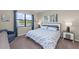 Main bedroom with a king-size bed and large windows at 20644 Swallow Tail Ct, Venice, FL 34293