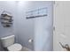 Powder room with toilet and floating shelves at 20644 Swallow Tail Ct, Venice, FL 34293