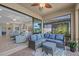 Relaxing screened porch with comfortable seating and a view of the backyard at 20644 Swallow Tail Ct, Venice, FL 34293