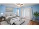 Spacious main bedroom featuring a comfortable bed and sliding doors to exterior at 224 Sky Loch E Dr, Dunedin, FL 34698