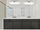 Double vanity bathroom with modern dark cabinets and quartz countertop at 32354 Wetland Bird Vw, San Antonio, FL 33576