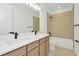 Double vanity bathroom with light wood cabinets and bathtub at 32354 Wetland Bird Vw, San Antonio, FL 33576