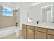 Modern bathroom with soaking tub, large vanity, and window at 32354 Wetland Bird Vw, San Antonio, FL 33576