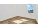 Simple bedroom with wood-look floors and a window with natural light at 32354 Wetland Bird Vw, San Antonio, FL 33576