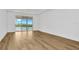 Spacious bedroom with wood-look floors and sliding glass doors leading to a balcony with water views at 32354 Wetland Bird Vw, San Antonio, FL 33576